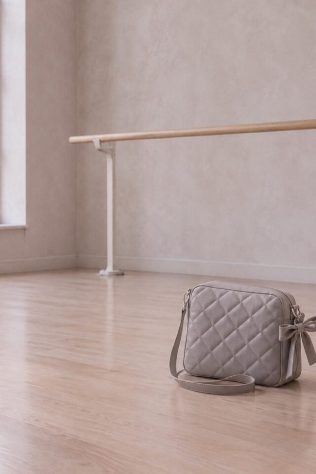 Cerise Quilted Bow Crossbody in ash grey faux leather, photographed in the studio.