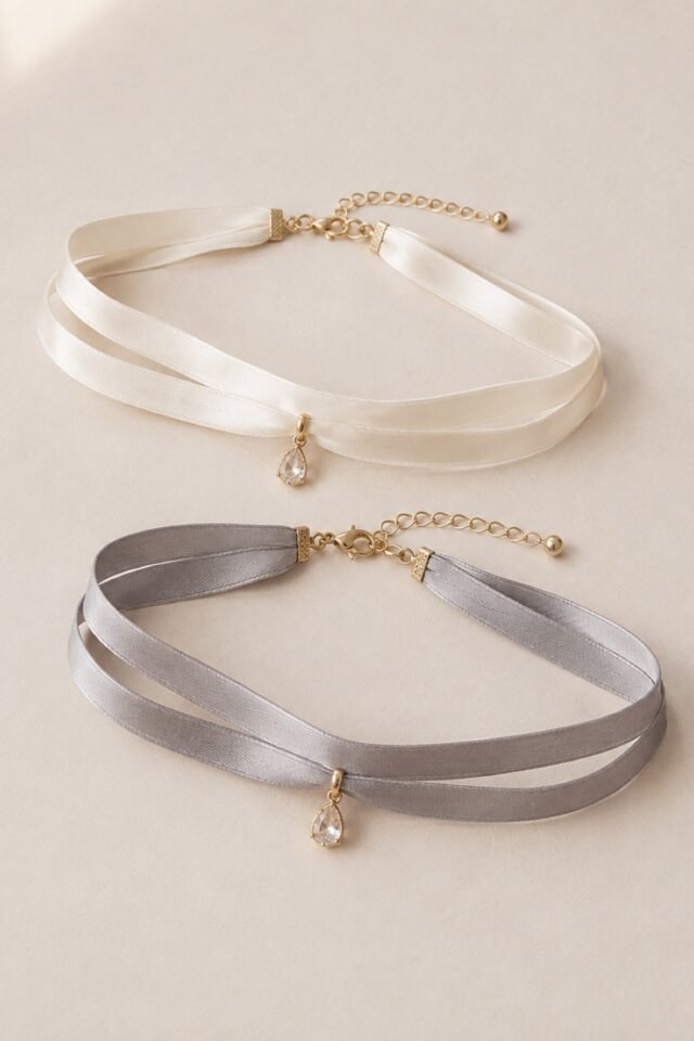 Faveur Double-Ribbon Choker in ivory and ash grey, laid flat.